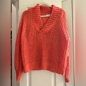 Orange knitted v-neck sweater from Anthropologie